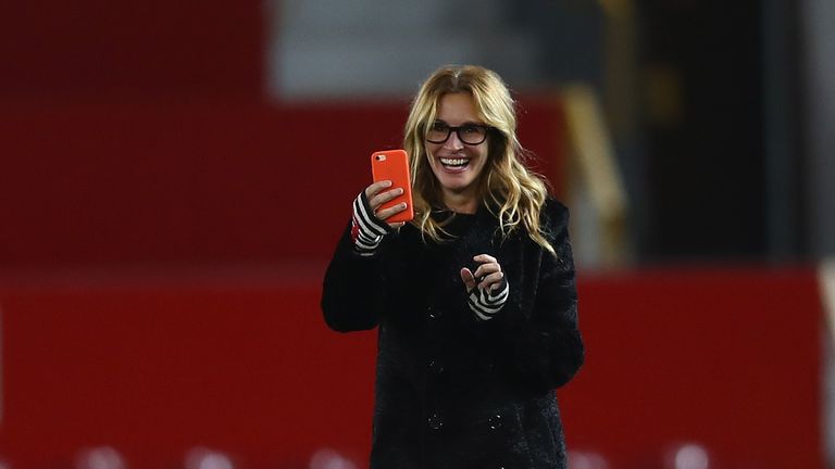 MANCHESTER, ENGLAND - NOVEMBER 27:  Actress Julia Roberts takes photos on the pitch after the Premier League match between Manchester United and West Ham U