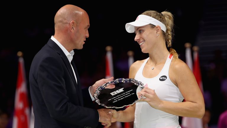 SINGAPORE - OCTOBER 30:  Runner up Angelique Kerber of Germany receives her trophy from Pierre Veyres of BNP after the singles final against Dominika Cibul