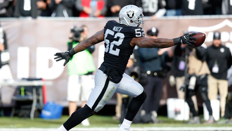 OAKLAND, CA - NOVEMBER 27:  Khalil Mack #52 of the Oakland Raiders scores after intercepting Cam Newton #1 of the Carolina Panthers in the second quarter o