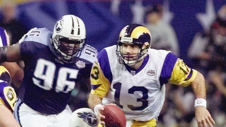 ATLANTA, UNITED STATES:  St. Louis Rams quarterback Kurt Warner (13) scrambles in an attempt to avoid the rush of the Tennessee Titans defense during first