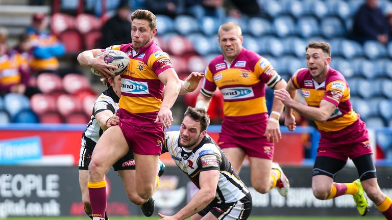 Huddersfield Giants v Salford Red Devils - John Smith's Stadium, Huddersfield's Kyle Wood is tackled by Salford's George Griffin and Logan Tomkins.