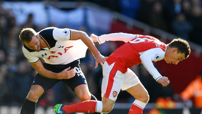 Laurent Koscielny of Arsenal and Harry Kane of Tottenham Hotspur battle for possession