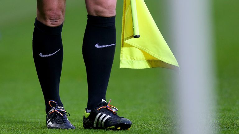 The assistant referee in the Leicester City v Middlesbrough gets involved with the rainbow laces