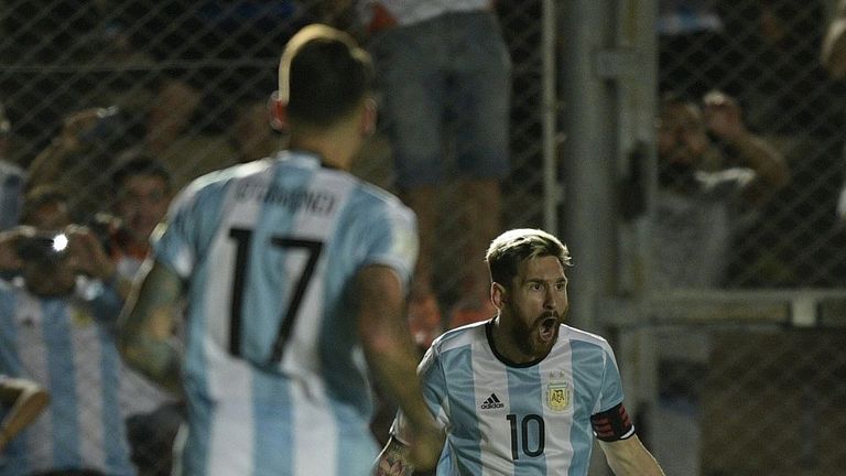 Argentina's Lionel Messi (R) celebrates with teammates after scoring against Colombia