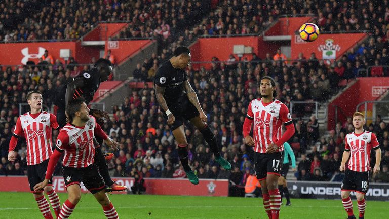 Liverpool's English defender Nathaniel Clyne (C) heads the ball towards goal but fails to score against Southampton