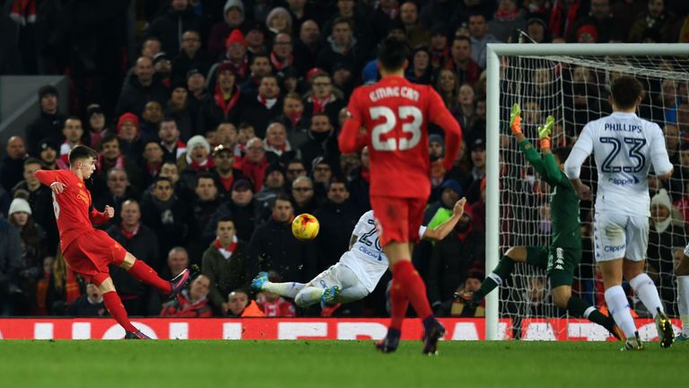 Liverpool's Welsh striker Ben Woodburn (L) scores his team's second goal during the English League Cup quarter-final football match between Liverpool and L