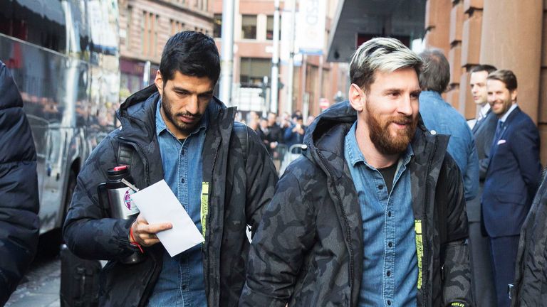 Lionel Messi (R) and Luis Suarez look relaxed as they arrive at their hotel in Glasgow