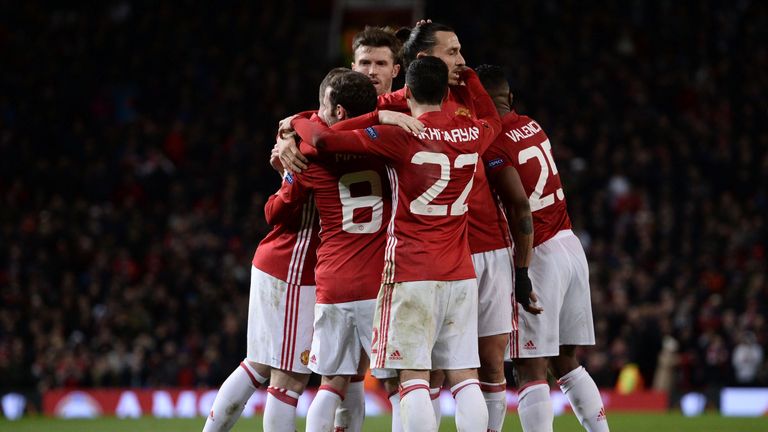 Manchester United players celebrate after Manchester United's Spanish midfielder Juan Mata (C) scored their second goal 