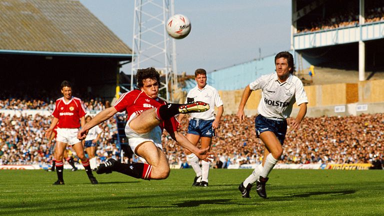 Manchester United player Mark Hughes in action watched by spurs players Paul Gascoigne (c) and Terry Fenwick (r)