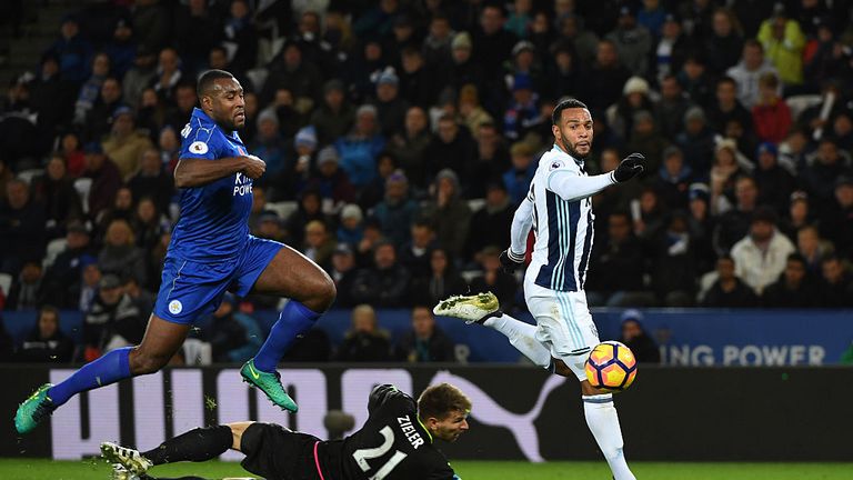 LEICESTER, ENGLAND - NOVEMBER 06:  Wes Morgan of Leicester City closes down Matt Phillips of West Bromwich Albion as he chips Ron-Robert Zieler of Leiceste