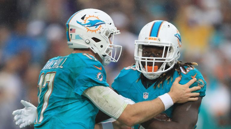 Quarterback Ryan Tannehill #17 and running back Jay Ajayi #23 of the Miami Dolphins discuss a play