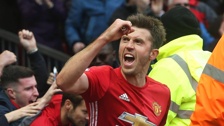 Michael Carrick celebrates after Juan Mata scores the opening goal against Arsenal