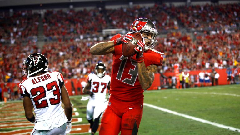 TAMPA, FL - NOVEMBER 3:  Wide receiver Mike Evans comes down after hauling in a 24-yard touchdown pass from quarterback Jameis Winston in front of cornerba