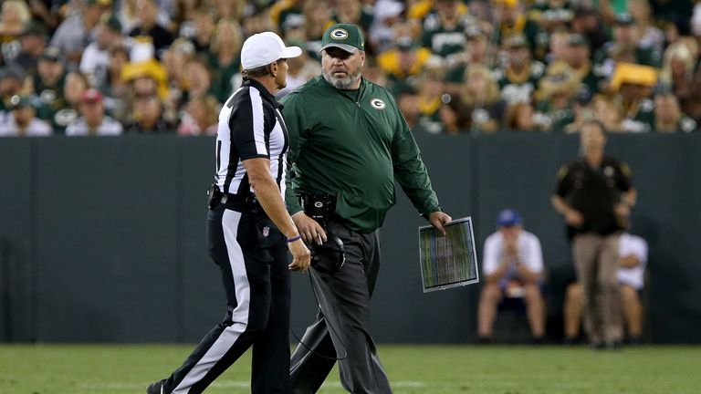 GREEN BAY, WI - AUGUST 12:  Head coach Mike McCarthy of the Green Bay Packers talks with official Mike Ed Hochuli in the second quarter against the Clevela