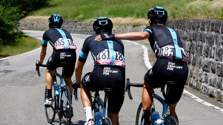 Spanish Mikel Landa (C) of team Sky is comforted by teammate David Lopez Garcia (R) and Spanish Mikel Nieve (L) during the 10th stage of 99th Giro d'Italia