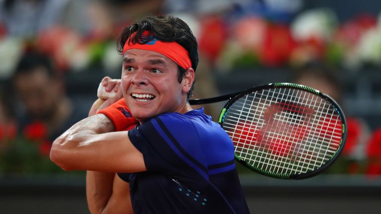 Milos Raonic of Canada in action against Novak Djokovic of Serbia in their quarter final round match in Madrid