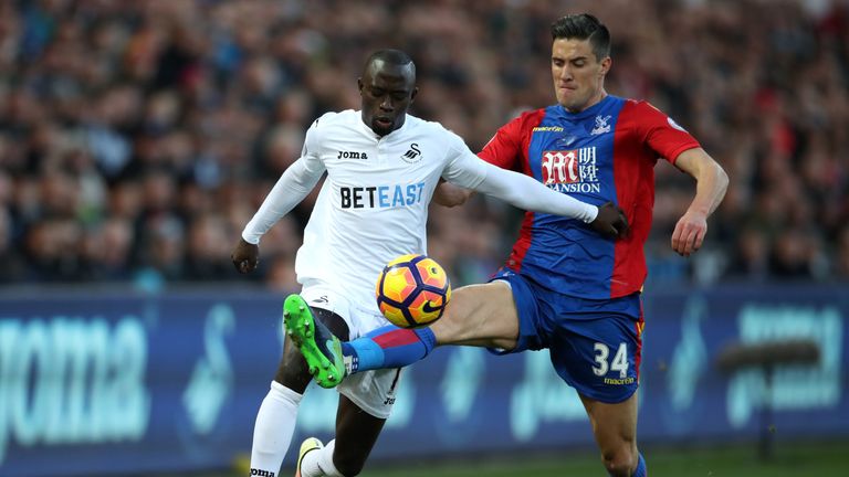 Swansea City's Modou Barrow and Crystal Palace's Martin Kelly (right) battle for the ball during the Premier League match at the Liberty Stadium, Swansea.