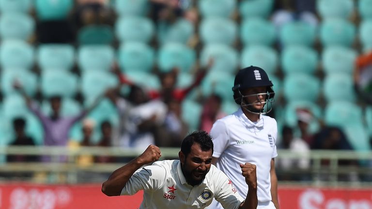 India's Mohhamed Shami (L) celebrates the wicket of England's Joe Root (R) during the last day of the second Test cricket match between India and England a
