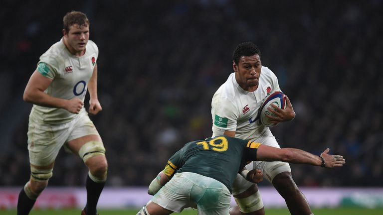 Nathan Hughes of England is tackled by Franco Mostert of South Africa