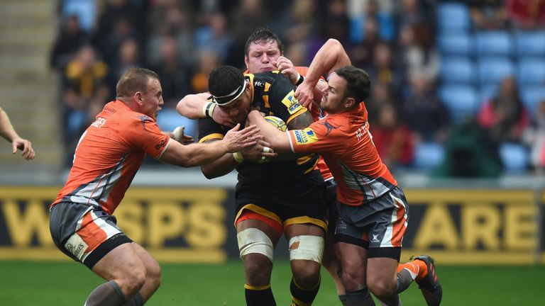 Hughes is tackled while playing for Wasps