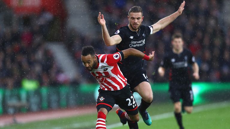 Nathan Redmond of Southampton (L) is fouled by Jordan Henderson