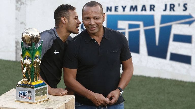 Brazilian Barcelona player Neymar (L) speaks to his father, former footballer Neymar Senior, during a five-a-side football match, as part of a Neymar Junio