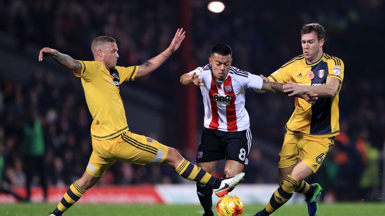 Brentford's Nico Yennaris battles for possession of the ball with Fulham's Ragnar Sigurdsson, (left) and Kevin McDonald, (right)