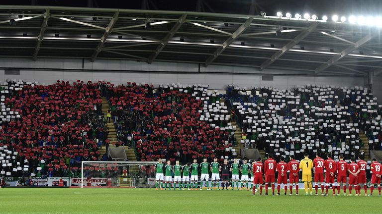 The Northern Ireland and Azerbaijan teams stand for a minutes' silence on Armistice Day before their World Cup qualifier