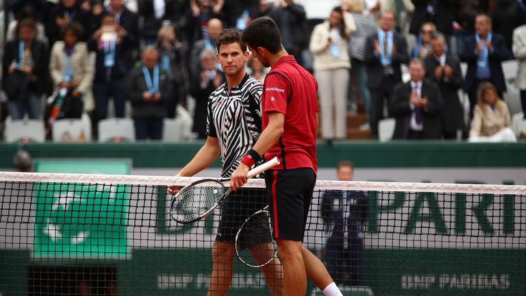Novak Djokovic of Serbia shakes hands with Dominic Thiem of Austria following his victory during the Men's Singles semi final mat