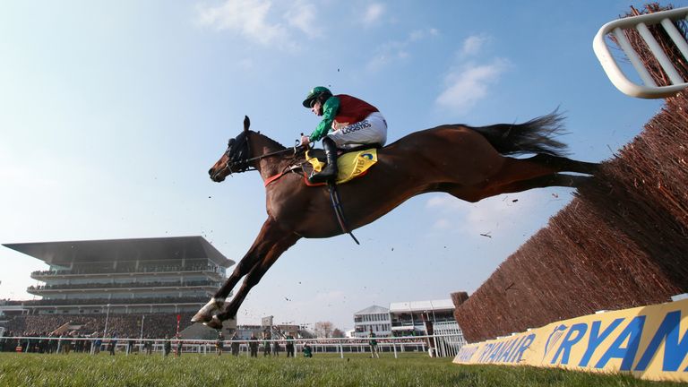 Oscar Rock ridden by Brian Hughes jumps the fence during the Ryanair Chase during St Patrick's Thursday of the 2016 Cheltenham Festival at Cheltenham Racec