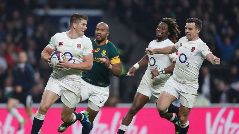 England's centre Owen Farrell (L) runs to score a try with England's fly half George Ford (R) and England's wing Marland Yarde (2R) 