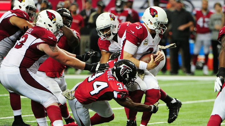 ATLANTA, GA - NOVEMBER 27: Carson Palmer #3 of the Arizona Cardinals is tackled by Brian Poole #34 of the Atlanta Falcons during the second half at the Geo