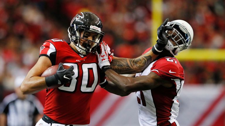 ATLANTA, GA - NOVEMBER 27: Levine Toilolo #80 of the Atlanta Falcons breaks a tackle by Patrick Peterson #21 of the Arizona Cardinals after a catch during 