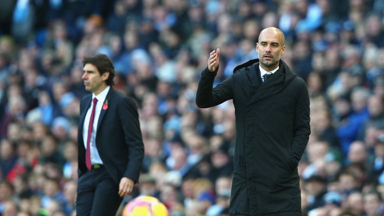 MANCHESTER, ENGLAND - NOVEMBER 05: Josep Guardiola, Manager of Manchester City (R) gives his team instructions during the Premier League match between Manc