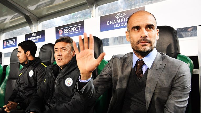 Man City manager Pep Guardiola waves from the dugout