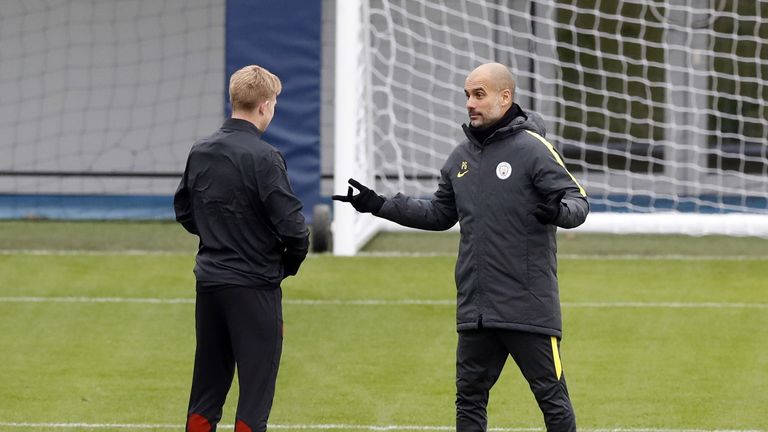 Manchester City manager Pep Guardiola with Kevin De Bruyne during a training session ahead of the UEFA Champions League group stage match at the City Footb