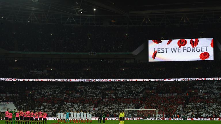 Players, officials and fans observe a silence in remembrance of Armistice Day prior to the FIFA 2018 World Cup qualifying m
