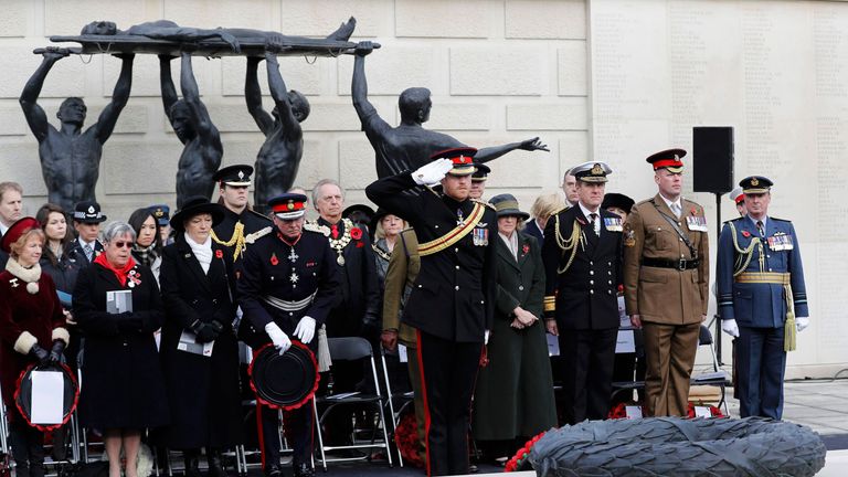 ALREWAS, STAFFORDSHIRE - NOVEMBER 11:  Prince Harry (C) salutes as joins others to attend The Armistice Day Service at The National Memorial Arboretum on N