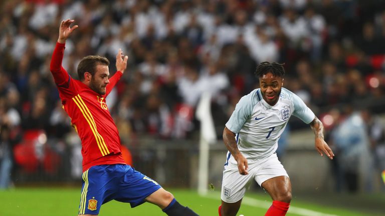 Raheem Sterling races past Juan Mata during the friendly between England and Spain 