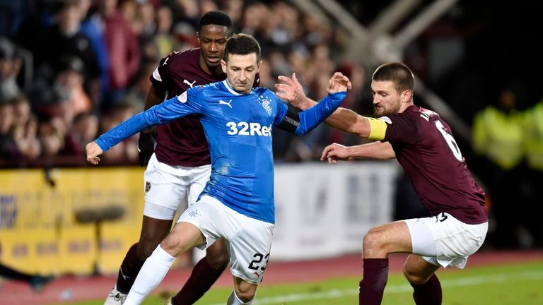 Rangers' Jason Holt runs from Hearts' Arnaud Djoum (left) and Perry Kitchen