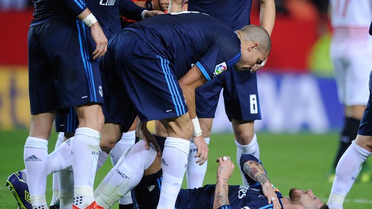 Pepe looks down at Real captain Sergio Ramos after he injured his shoulder