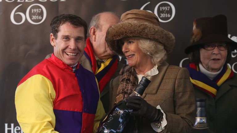 The Duchess of Cornwall presents Richard Johnson with his trophy after the Hennessy Gold Cup