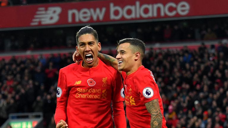 Liverpool's Roberto Firmino celebrates scoring his side's fourth goal of the game with Philippe Coutinho (right) during the Premier League match at Anfield