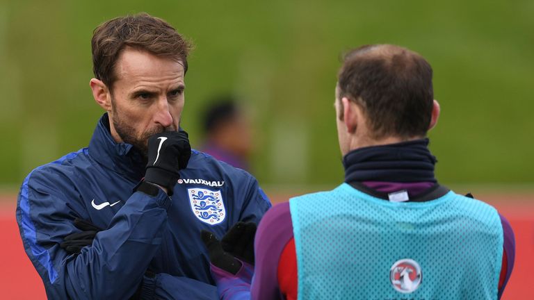 England's Interim manager Gareth Southgate (L) talks with England's striker Wayne Rooney 