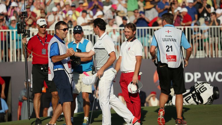 DUBAI, UNITED ARAB EMIRATES - NOVEMBER 22:  Rory McIlroy of Northern Ireland and hjis caddie JP Fitzgerald celebrate on the 18th green as Andy Sullivan of 