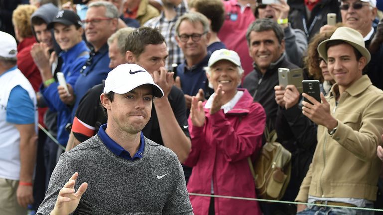 Irish Rory McIlroy gestures as he arrives on the 1st tee during the third round of the 100th French Golf Open on July 2, 2016 at Le Golf National in Guyanc