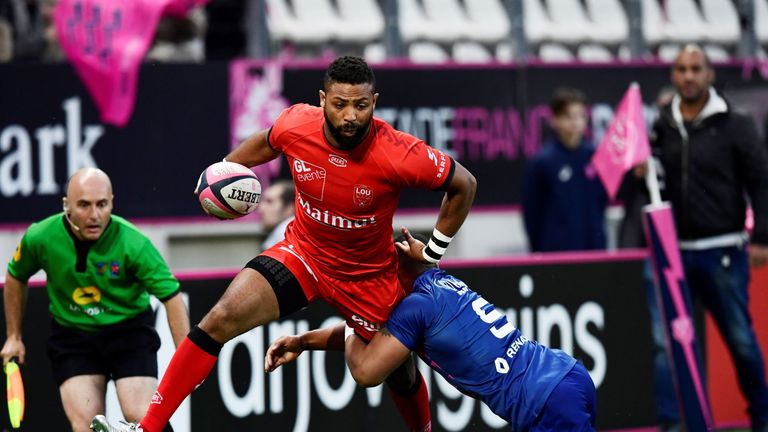 Lyon full-back Delon Armitage (left) is tackled by Stade Francais scrum-half Will Genia