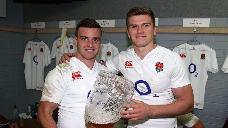 Owen Farrell (R) and George Ford hold the Cook Cup after England's series victory over Australia
