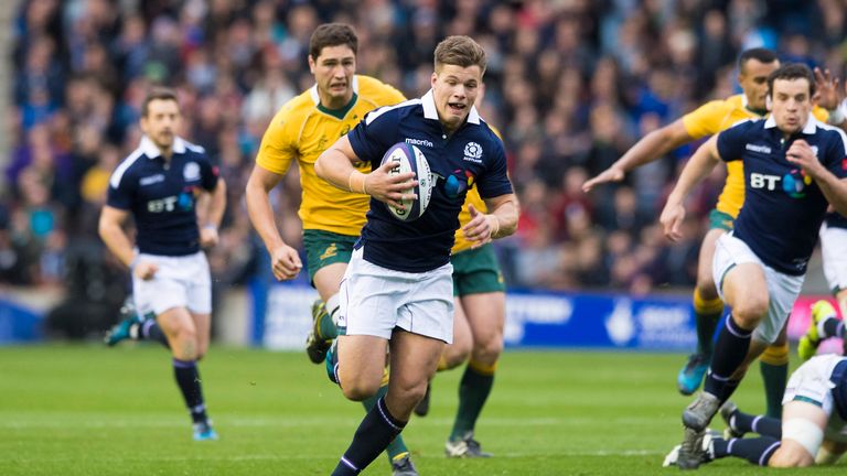 Huw Jones runs through to score Scotland's first try against Australia