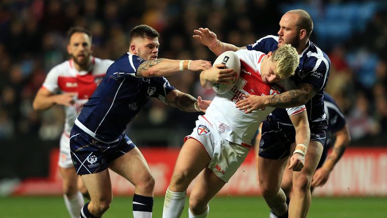 England's George Williams fight off the close attentions of the Scottish defence